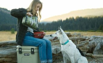 A young woman pouring NWN product in her dogs bowl